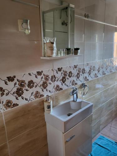 a bathroom with a sink and a mirror at Rijeka apartment with free parking and large balcony in Rijeka