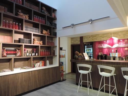a bar in a restaurant with stools at BEST WESTERN Hotel Brussels South in Ruisbroek