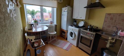 a small kitchen with a sink and a dishwasher at Dzīvoklis 17 in Rūjiena