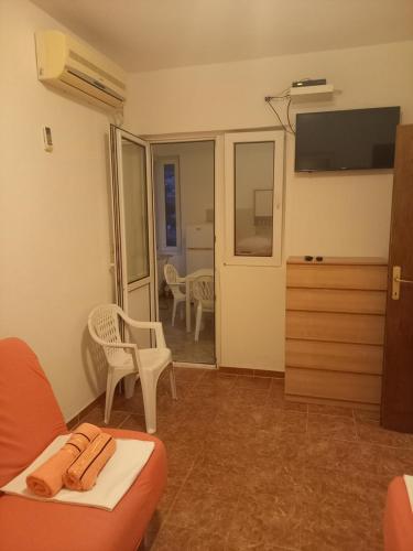 a living room with a couch and a tv at Apartmani Stojanović in Sutomore