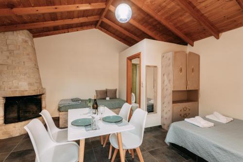 a dining room with a table and chairs and a fireplace at Elenis Spiti in Moírai