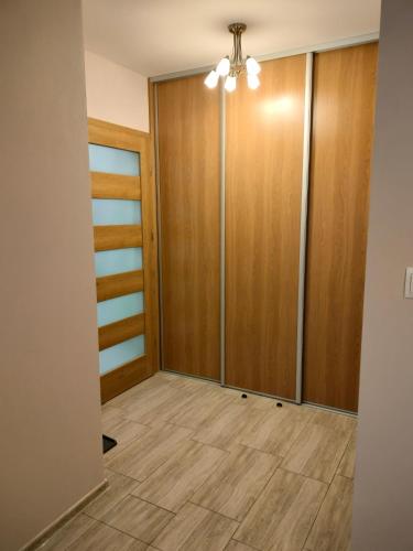 a room with wooden doors and a floor at Bieszczadzkie Szlaki in Lutowiska