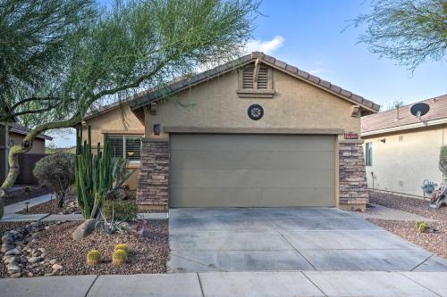 a house with a garage door in a yard at Luxe Anthem Home with Grilling Patio Near Hiking! in Anthem