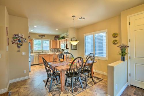 a kitchen and dining room with a table and chairs at Luxe Anthem Home with Grilling Patio Near Hiking! in Anthem