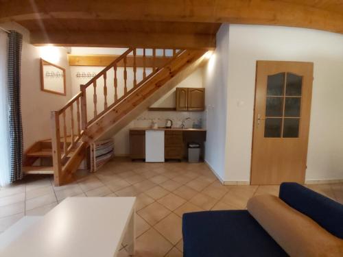 a living room with a staircase and a kitchen at Pokoje Podzamcze in Stare Drawsko