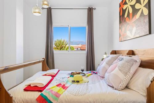 a bedroom with a bed with a window at Villa Amapola in El Médano
