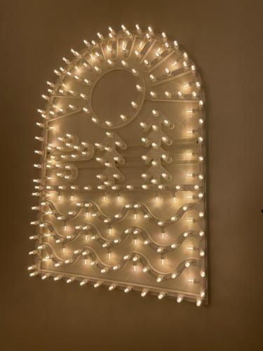 a mirror with lights on a wall at Elementi Luxury House in Otranto