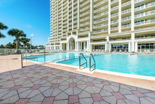 a swimming pool in front of a large building at Ariel Dunes I 1401 in Destin