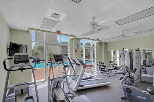 a gym with cardio equipment and a swimming pool at Ariel Dunes I 1401 in Destin