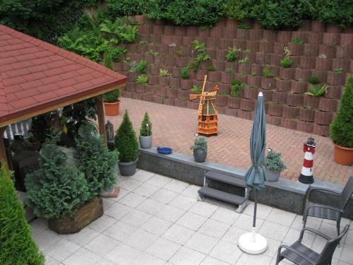 a patio with a garden with a lighthouse and an umbrella at Ferienwohnung Am Berggipfel in Wieda