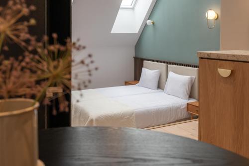 a small room with a bed and a table at Monciak55 Sopot Apartments in Sopot