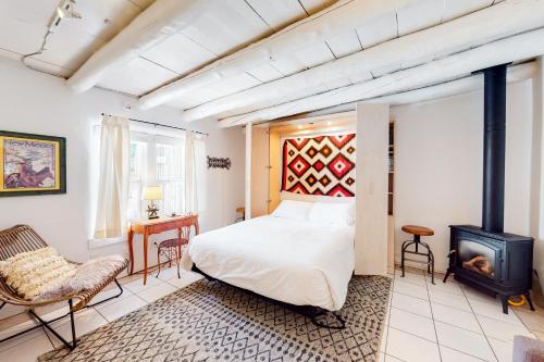 a bedroom with a bed and a fireplace at Casita Testoro in Santa Fe