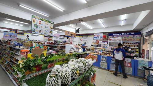 a man standing in a grocery store aisle at Trivium Terrace Apartment Lippo Cikarang EJIP -Min Stay 3 Nights- in Bekasi