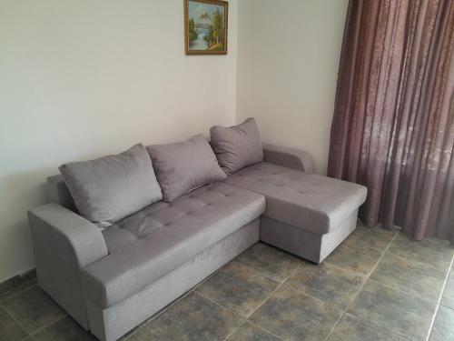 a couch with two pillows on it in a room at Mijovic Apartments in Budva