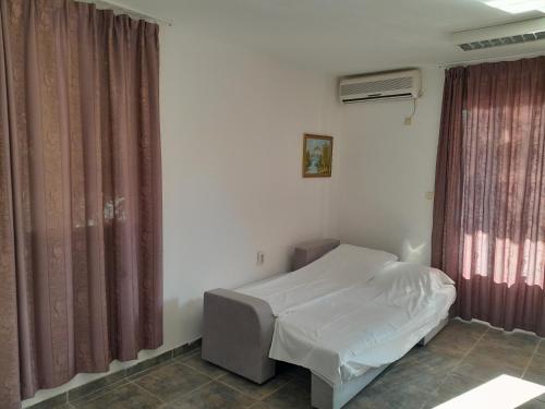 a hospital room with a bed and a window at Mijovic Apartments in Budva