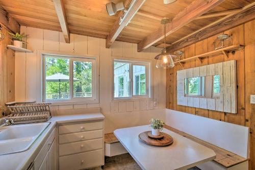 a kitchen with white counters and wooden ceilings and windows at Lakeview Lodge Fit for Groups Less Than 1 Mile to Lake! in Lake Arrowhead