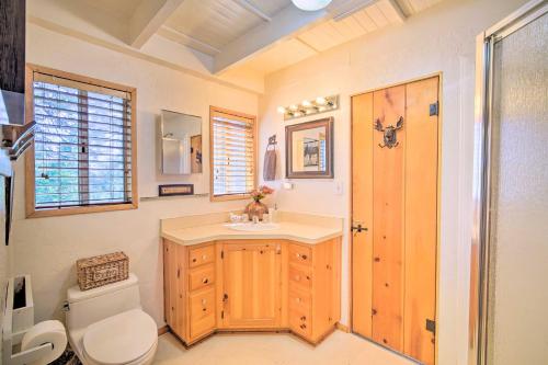 a bathroom with a white toilet and a sink at Lakeview Lodge Fit for Groups Less Than 1 Mile to Lake! in Lake Arrowhead