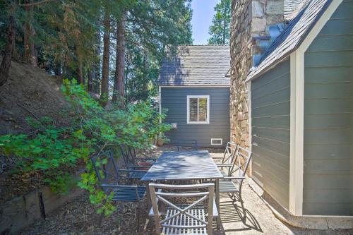 a patio with a table and chairs next to a house at Lakeview Lodge Fit for Groups Less Than 1 Mile to Lake! in Lake Arrowhead