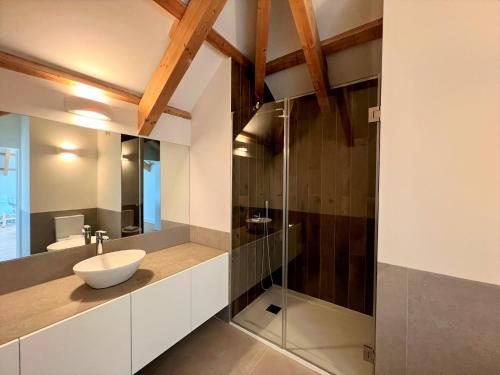 a bathroom with a sink and a glass shower at Faro Design 7 by Homing in Faro