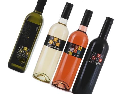 four bottles of wine sitting next to each other at Hiša Ivančič in Šared