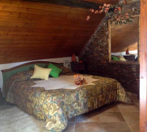 a bedroom with a bed in a stone wall at Le Radici in Sassello