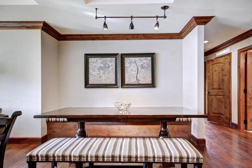 a dining room with a table and a bench at Ritz Carlton Vail #200 condo in Vail