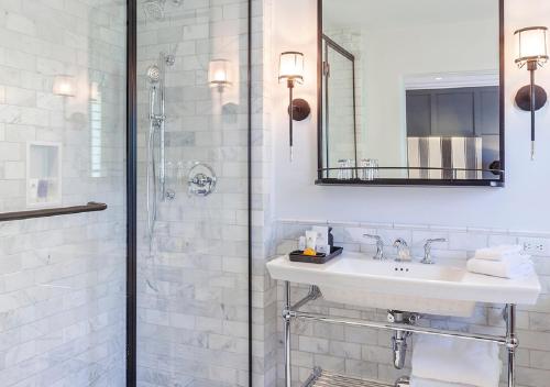 a white bathroom with a sink and a shower at Ojai Valley Inn in Ojai