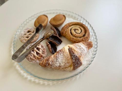 a glass plate with pastries and cookies on a table at La Casa Dei Nonni in Matera