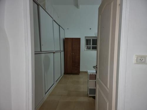 an empty hallway with a door to a room at Tannous Aparthotel in Haifa