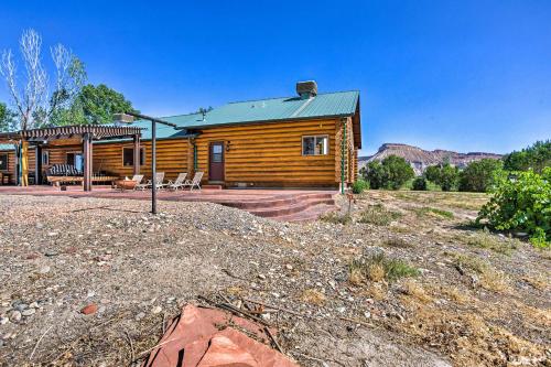 a log cabin with a patio in front of it at Clifton Retreat with Breathtaking Mt Backdrop! in Clifton