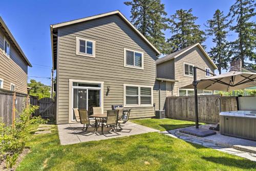 a patio with a table and chairs in a yard at Portland Home with Private Hot Tub 9 Mi to Downtown in Milwaukie