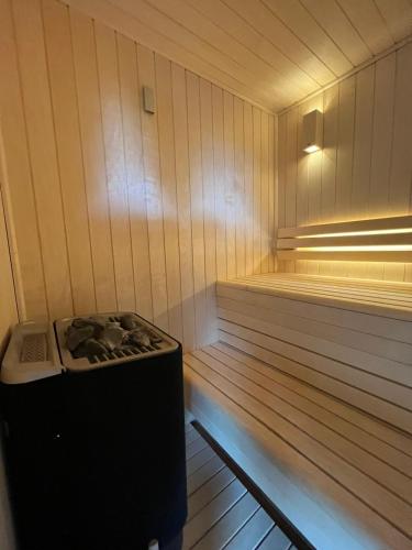 a inside of a sauna with a stove in it at Charmante Cabane dans les arbres avec jacuzzi et sauna in Boismorand