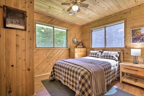 a bedroom with a bed in a wooden cabin at Cozy Florence Cabin, Proximity to Keyes Peak! in Florence