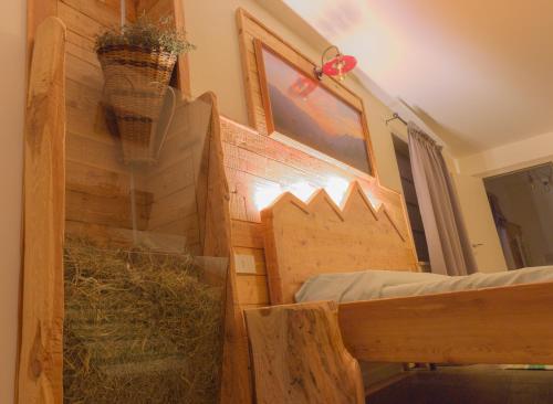 a room with a barn with hay on the wall at Ca' di Pazient in Teglio