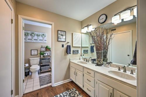 a bathroom with a sink and a toilet and a mirror at Beautiful Hot Springs Condo with Lake Hamilton Views in Hot Springs