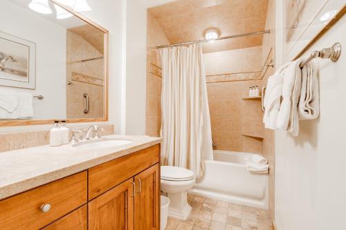 a bathroom with a sink and a toilet and a tub at Golf Creek 11 in Jackson