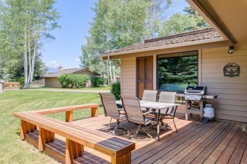 a deck with a table and chairs and a grill at Golf Creek 11 in Jackson