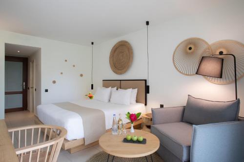 a hotel room with a bed and a couch at Blue Sea Beach Affiliated By Melia in Stalida