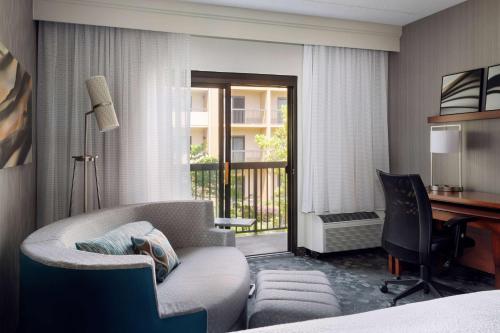 a hotel room with a bed and a desk and a chair at Sonesta Select Whippany Hanover in Whippany