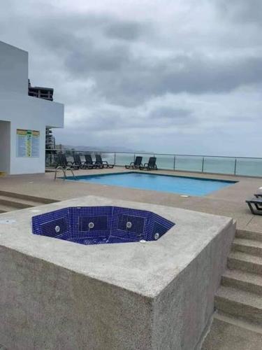a blue object sitting on a wall next to a swimming pool at Hermosa suit 610 Makana, Tonsupa-Atacames-Esmeraldas in Tonsupa