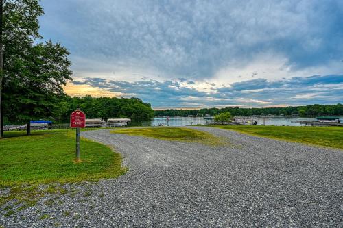a stop sign on a gravel road next to a lake at The Last Cast in Bumpass
