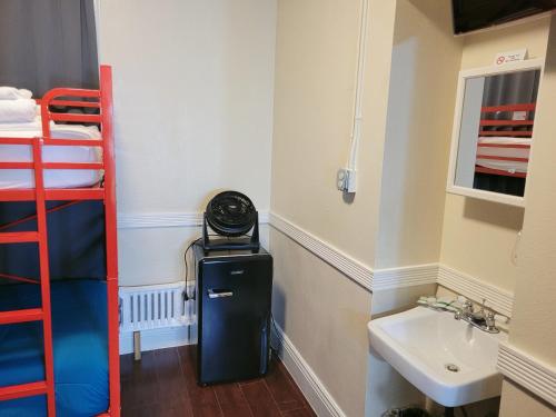 a room with a sink and a bunk bed at Orange Village Hostel in San Francisco