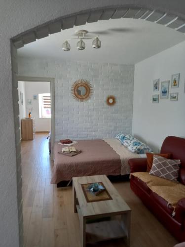 a bedroom with a bed and a couch and a table at Old marine house in Tivat