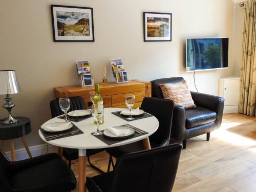 a dining room with a white table and chairs at Lough Álainn - Tourism NI Certified in Warrenpoint