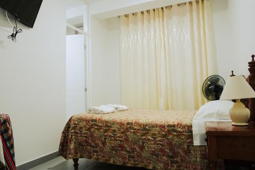 Ένα ή περισσότερα κρεβάτια σε δωμάτιο στο Hospedaje El Velero