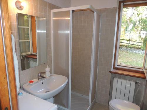 a bathroom with a shower and a sink and a toilet at Ico's Lodge in Sauze dʼOulx