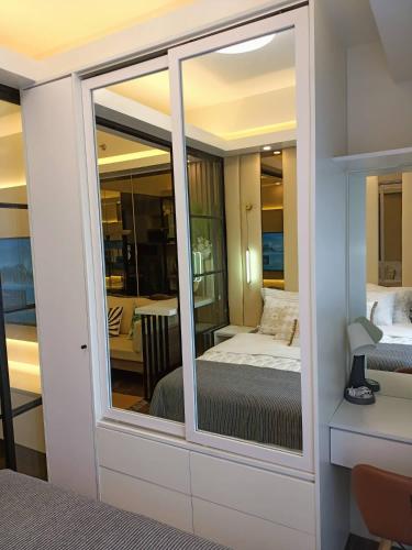a room with a window with a bed and a table at Luxurious Condotel at the heart of Makati in Manila