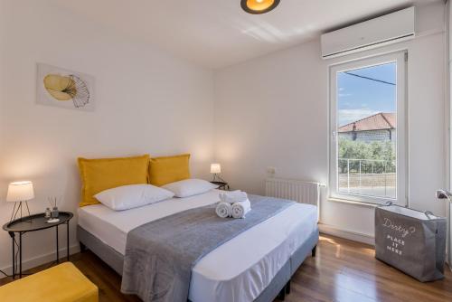 a bedroom with a bed and a large window at Villa Trogir save 15 percent on Split-villas com in Trogir