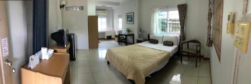 a bedroom with a bed in a room at Pikul Apartment Hotel in Nong Khai