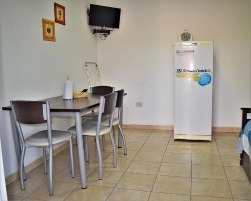 a dining room with a table and a refrigerator at Cabañas Ceferino in Federación